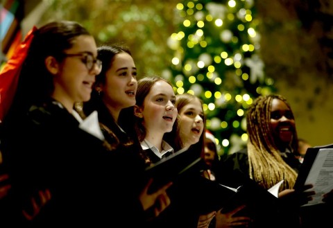 Members of a school choir singing indoors at LH2000 at the annual lighting of the Leinster House Christmas tree event